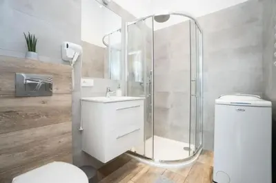 a bathroom with a shower and a toilet and a sink at Old Town Apartments - B22 in Kraków