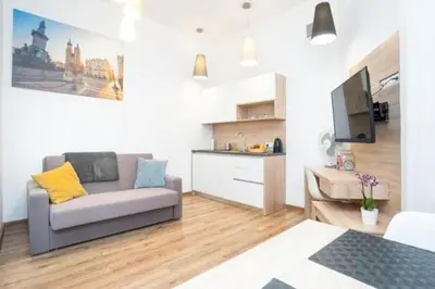 a living room with a couch and a tv at Old Town Apartments - B22 in Kraków