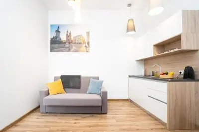 a living room with a couch in a kitchen at Old Town Apartments - B22 in Kraków