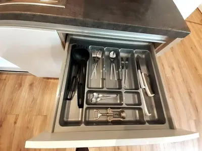 a drawer filled with utensils in a refrigerator at Old Town Apartments - B22 in Kraków