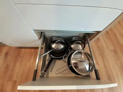 a shelf with four pots and pans on a table at Old Town Apartments - B22 in Kraków