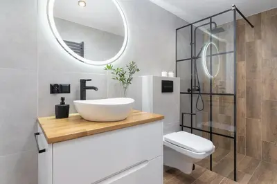 a bathroom with a sink and a toilet and a mirror at Modern Apartment in Kazimierz District - Józefa 2 in Kraków