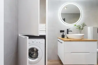 a bathroom with a washing machine and a sink at Modern Apartment in Kazimierz District - Józefa 2 in Kraków