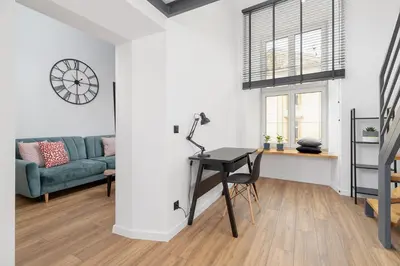 a living room with a desk and a couch at Modern Apartment in Kazimierz District - Józefa 2 in Kraków