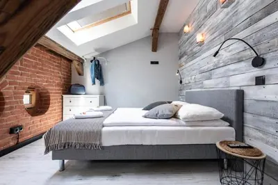 a bedroom with a bed and a brick wall at Studio for two with an AC - Dietla 51 street in Kraków