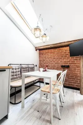 a dining room with a white table and chairs at Studio for two with an AC - Dietla 51 street in Kraków