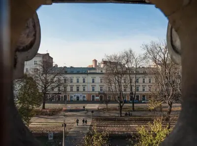 a view of a large building with people walking in front of it at Studio for two with an AC - Dietla 51 street in Kraków