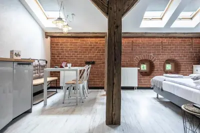 a bedroom with a bed and a brick wall at Studio for two with an AC - Dietla 51 street in Kraków
