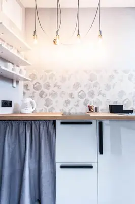 a kitchen with white cabinets and a counter top at Studio for two with an AC - Dietla 51 street in Kraków
