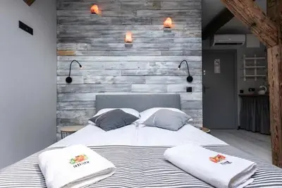 a bedroom with a bed with two pillows on it at Studio for two with an AC - Dietla 51 street in Kraków