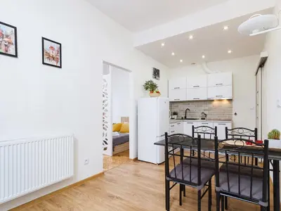 a kitchen and dining room with a table and chairs at 1 Bedroom Apartment - Starowiślna 54 in Kraków