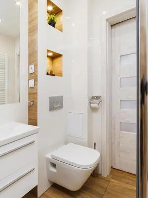 a white bathroom with a toilet and a sink at 1 Bedroom Apartment - Starowiślna 54 in Kraków