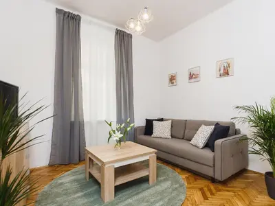 a living room with a couch and a coffee table at 1 Bedroom Apartment - Starowiślna 54 in Kraków