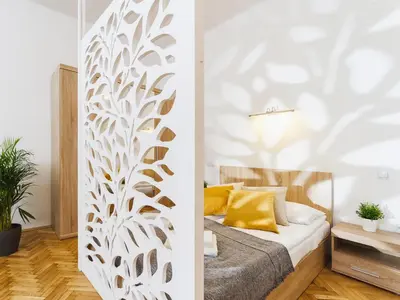 a bedroom with a bed with a white wall at 1 Bedroom Apartment - Starowiślna 54 in Kraków