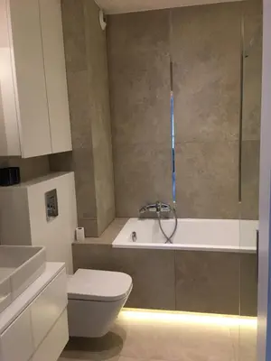 a glass shower stall with a toilet in a bathroom at Wrocławska 53 - Duży i Wygodny apartament in Kraków