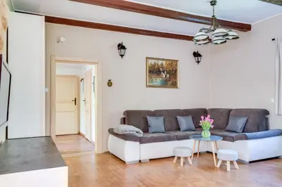 a living room with a couch and a table at Domek Jędrusiówka in Sułkowice