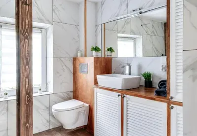 a bathroom with a white toilet and a sink at Domek Jędrusiówka in Sułkowice