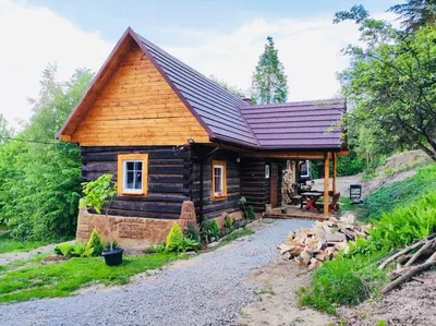 a log cabin with a red roof at Domek Jędrusiówka in Sułkowice
