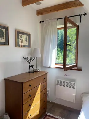 a bedroom with a dresser and a window at Dom w górach - Jelenia Chata in Zawoja
