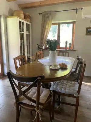 a dining room with a wooden table and chairs at Dom w górach - Jelenia Chata in Zawoja