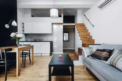 a living room with a couch and a table at Apartment with mezzanine - Radziwiłłowska 27 in Kraków