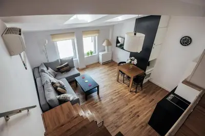a living room with a couch and a table at Apartment with mezzanine - Radziwiłłowska 27 in Kraków