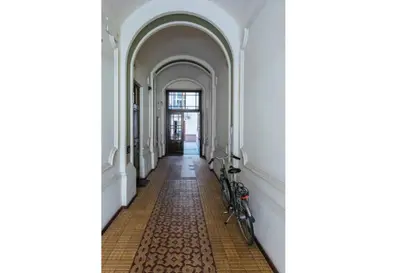 a hallway with a bike parked in a building at Apartment with mezzanine - Radziwiłłowska 27 in Kraków