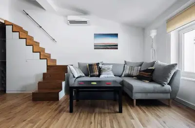 a living room with a couch and a table at Apartment with mezzanine - Radziwiłłowska 27 in Kraków