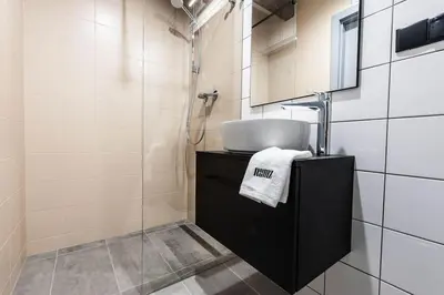 a bathroom with a sink and a shower at Studio apartment with an AC - Dietla 51 street in Kraków