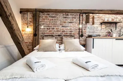 a large white bed with two pillows on it at Studio apartment with an AC - Dietla 51 street in Kraków