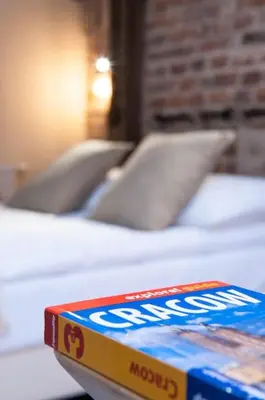 a box of chips sitting on top of a bed at Studio apartment with an AC - Dietla 51 street in Kraków