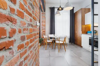 a kitchen and dining room with a brick wall at Kazimierz District - Miodowa 32 Street in Kraków