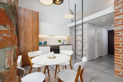 a kitchen and dining room with a white table and chairs at Kazimierz District - Miodowa 32 Street in Kraków