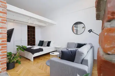 a living room with a couch and a table at Kazimierz District - Miodowa 32 Street in Kraków