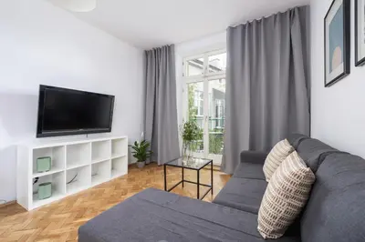 a living room with a couch and a tv at 1-Bedroom Apartment with Balcony - Długa 65 in Kraków