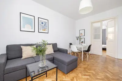 a living room with a couch and a table at 1-Bedroom Apartment with Balcony - Długa 65 in Kraków
