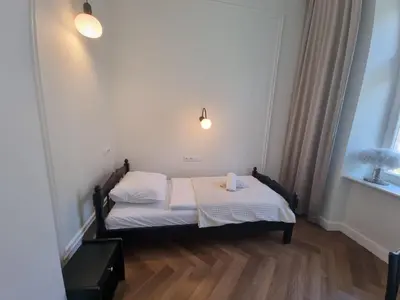 a small bedroom with a bed with a towel on it at Apartamenty Inspiracja in Kraków