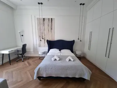 a bedroom with a bed with two white towels on it at Apartamenty Inspiracja in Kraków