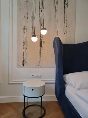 a room with a bed and a table and a couch at Apartamenty Inspiracja in Kraków