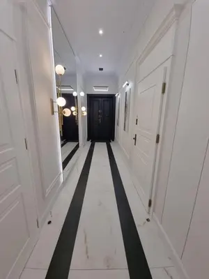 a hallway with a black and white hallway at Apartamenty Inspiracja in Kraków