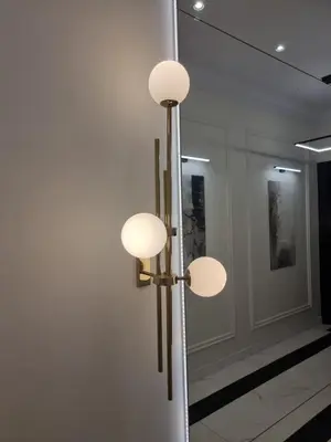 a room with three lights on a wall at Apartamenty Inspiracja in Kraków