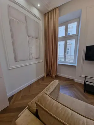 a living room with a couch and a window at Apartamenty Inspiracja in Kraków