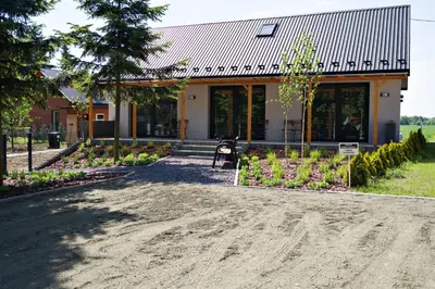a house with a dirt road in front of it at Nadwiślańska Apartments - Lipowa, 11km od Zator, Energylandia in Zator