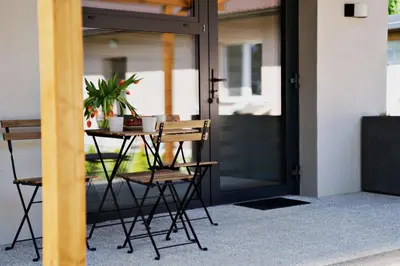 a table and chairs in front of a door at Nadwiślańska Apartments - Lipowa, 11km od Zator, Energylandia in Zator