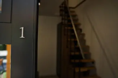 a spiral staircase in a building with the number on it at Nadwiślańska Apartments - Lipowa, 11km od Zator, Energylandia in Zator