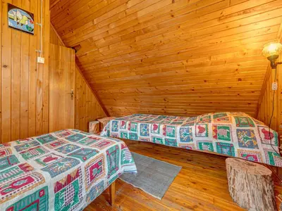 a bedroom with two beds in a log cabin at Holiday Home Hatale by Interhome in Rzyki