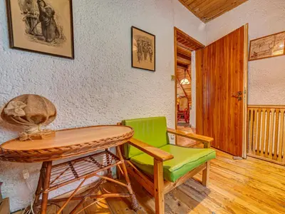 a room with a table and a green chair at Holiday Home Hatale by Interhome in Rzyki