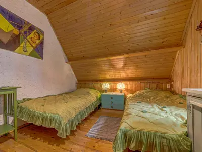 a bedroom with two beds and a wooden ceiling at Holiday Home Hatale by Interhome in Rzyki