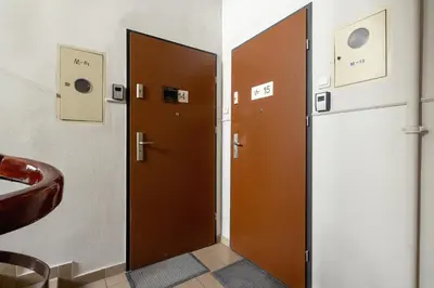 two brown doors in a bathroom with a sink at 2-Bedroom Apartment - Długa 65 in Kraków