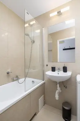 a bathroom with a sink and a shower and a tub at 1-Bedroom Apartment - Długa 65 in Kraków